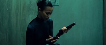 Movie still from “Colombiana” (2011), directed by Olivier Megaton – A woman holding an ar - 1 5 style rifle in her hands; Medium shot, Low angle