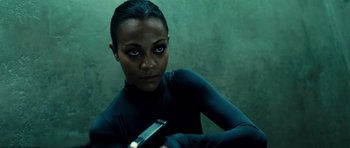 Movie still from “Colombiana” (2011), directed by Olivier Megaton – A woman holding a gun while wearing a black outfit; Close Up shot, Low angle