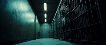 Movie still from “Colombiana” (2011), directed by Olivier Megaton – A jail cell with a door open to a cell block; Extreme Wide shot, Low angle