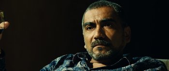 Movie still from “Colombiana” (2011), directed by Olivier Megaton – A person with a beard; Close Up shot, Over the shoulder angle