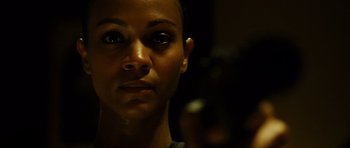 Movie still from “Colombiana” (2011), directed by Olivier Megaton – A woman's face in the dark; Close Up shot, Over the shoulder angle