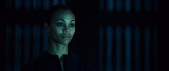 Movie still from “Colombiana” (2011), directed by Olivier Megaton – A woman in a black jacket is in the dark; Close Up shot, Low angle