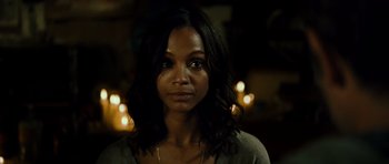 Movie still from “Colombiana” (2011), directed by Olivier Megaton – A beautiful woman with long black hair wearing a gray shirt; Close Up shot, Over the shoulder angle