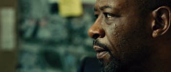 Movie still from “Colombiana” (2011), directed by Olivier Megaton – A man's face with dirt on his face; Extreme Close Up shot, Over the shoulder angle