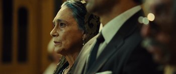 Movie still from “Colombiana” (2011), directed by Olivier Megaton – An older woman and a younger man in suits; Close Up shot, Over the shoulder angle
