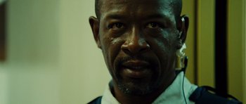 Movie still from “Colombiana” (2011), directed by Olivier Megaton – A man's face in a white shirt; Close Up shot, Low angle