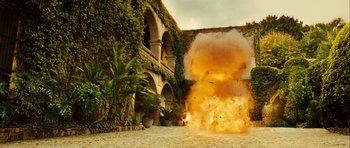 Movie still from “Colombiana” (2011), directed by Olivier Megaton – An image of an explosion coming out of a building; Extreme Wide shot, Low angle