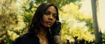 Movie still from “Colombiana” (2011), directed by Olivier Megaton – A woman with a black shirt and black leather gloves; Close Up shot, Low angle