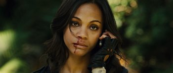 Movie still from “Colombiana” (2011), directed by Olivier Megaton – A woman with a black leather glove holding her hand up to her face; Close Up shot, High angle