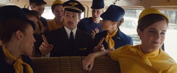 Movie still from “Colonia” (2015), directed by Florian Gallenberger – A group of people dressed as airline pilots on a train; Medium shot, Low angle