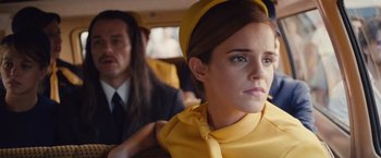 Movie still from “Colonia” (2015), directed by Florian Gallenberger – A woman in a yellow dress sitting next to a man in a suit; Close Up shot, Low angle