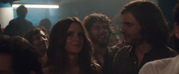 Movie still from “Colonia” (2015), directed by Florian Gallenberger – A group of people standing in a room with lights in the background; Close Up shot, Over the shoulder angle