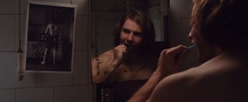 Movie still from “Colonia” (2015), directed by Florian Gallenberger – A man brushing his teeth in a bathroom mirror; Close Up shot, Over the shoulder angle