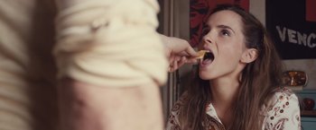 Movie still from “Colonia” (2015), directed by Florian Gallenberger – A woman taking a bite out of a piece of food; Close Up shot, Over the shoulder angle