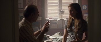 Movie still from “Colonia” (2015), directed by Florian Gallenberger – A man and a woman are talking in a room; Medium shot, Over the shoulder angle