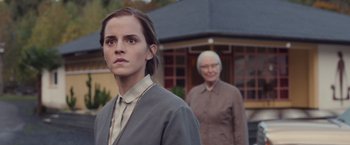Movie still from “Colonia” (2015), directed by Florian Gallenberger – Two women standing next to each other in front of a building; Close Up shot, Over the shoulder angle