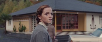 Movie still from “Colonia” (2015), directed by Florian Gallenberger – A young woman is standing in front of a building; Close Up shot, Over the shoulder angle