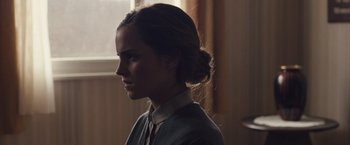 Movie still from “Colonia” (2015), directed by Florian Gallenberger – A woman with long brown hair wearing a dress; Close Up shot, Over the shoulder angle