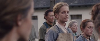 Movie still from “Colonia” (2015), directed by Florian Gallenberger – A group of people standing next to each other; Close Up shot, Over the shoulder angle