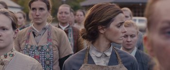 Movie still from “Colonia” (2015), directed by Florian Gallenberger – A group of people standing in a line; Close Up shot, Over the shoulder angle