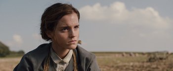 Movie still from “Colonia” (2015), directed by Florian Gallenberger – A woman in a field looking to her left; Close Up shot, Low angle