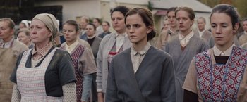 Movie still from “Colonia” (2015), directed by Florian Gallenberger – A group of people standing in front of each other; Medium shot, Low angle