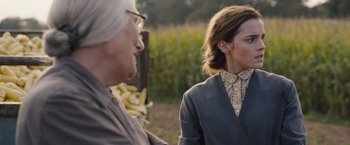 Movie still from “Colonia” (2015), directed by Florian Gallenberger – Two people standing next to each other near a field; Medium shot, Over the shoulder angle