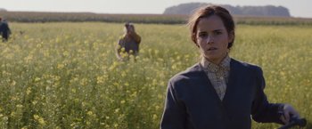 Movie still from “Colonia” (2015), directed by Florian Gallenberger – A woman standing in the middle of a flower field; Medium shot, Low angle