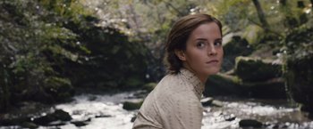 Movie still from “Colonia” (2015), directed by Florian Gallenberger – A young woman is standing in front of a river; Close Up shot, Low angle