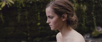 Movie still from “Colonia” (2015), directed by Florian Gallenberger – A person wearing a bra near a tree; Close Up shot, Low angle