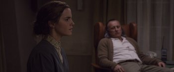 Movie still from “Colonia” (2015), directed by Florian Gallenberger – A man and a woman sitting next to each other; Medium shot, Over the shoulder angle