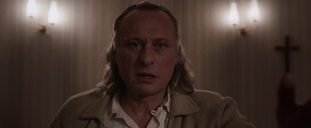Movie still from “Colonia” (2015), directed by Florian Gallenberger – A person with long hair; Close Up shot, Low angle