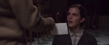Movie still from “Colonia” (2015), directed by Florian Gallenberger – A woman holding a piece of paper in front of her face; Close Up shot, Over the shoulder angle
