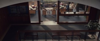 Movie still from “Colonia” (2015), directed by Florian Gallenberger – A view of an office from the top of the stairs; Extreme Wide shot, High angle
