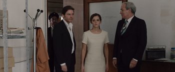 Movie still from “Colonia” (2015), directed by Florian Gallenberger – A man and a woman standing next to each other in front of a door; Medium shot, Over the shoulder angle