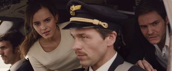 Movie still from “Colonia” (2015), directed by Florian Gallenberger – A man wearing a hat and a woman wearing a dress suit; Close Up shot, Over the shoulder angle