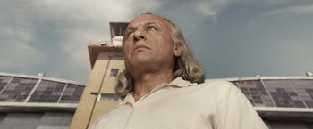 Movie still from “Colonia” (2015), directed by Florian Gallenberger – A person with long white hair looking up; Close Up shot, Low angle