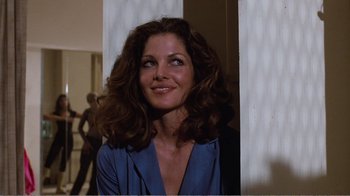 Movie still from “Coma” (1978), directed by Michael Crichton – A woman in a blue shirt is looking up; Medium shot, Low angle