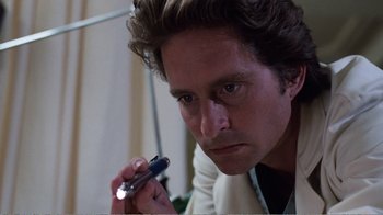 Movie still from “Coma” (1978), directed by Michael Crichton – A person holding a cell phone; Close Up shot, Low angle