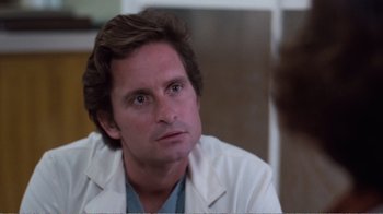 Movie still from “Coma” (1978), directed by Michael Crichton – A person wearing a white lab coat; Close Up shot, Over the shoulder angle