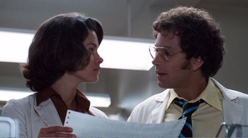Movie still from “Coma” (1978), directed by Michael Crichton – A man and a woman looking at a piece of paper; Close Up shot, Low angle