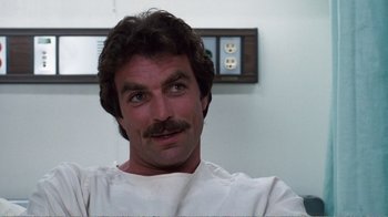 Movie still from “Coma” (1978), directed by Michael Crichton – A person with a mustache; Close Up shot, Low angle