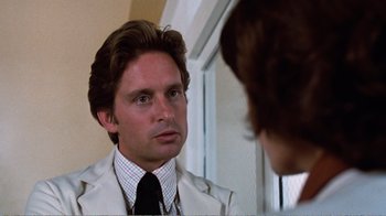 Movie still from “Coma” (1978), directed by Michael Crichton – A man looking at himself in the mirror; Close Up shot, Over the shoulder angle