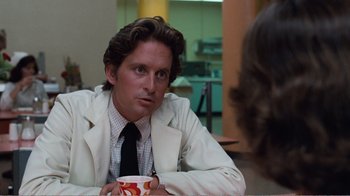 Movie still from “Coma” (1978), directed by Michael Crichton – A man in a white jacket holding a coffee cup; Close Up shot, Over the shoulder angle