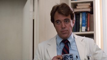 Movie still from “Coma” (1978), directed by Michael Crichton – A person wearing a suit and tie; Close Up shot, Over the shoulder angle