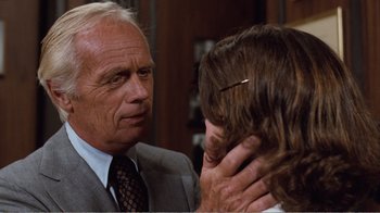 Movie still from “Coma” (1978), directed by Michael Crichton – An older man and a young woman in a room; Close Up shot, Over the shoulder angle