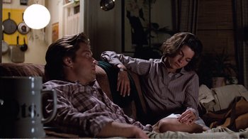 Movie still from “Coma” (1978), directed by Michael Crichton – A man and a woman sitting on a couch; Medium shot, Low angle