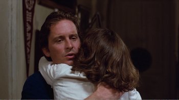 Movie still from “Coma” (1978), directed by Michael Crichton – A man and a woman hugging each other in a room; Close Up shot, Over the shoulder angle