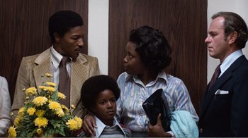 Movie still from “Coma” (1978), directed by Michael Crichton – A man and a woman and a boy in a room; Medium shot, Low angle