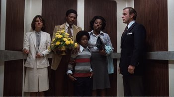 Movie still from “Coma” (1978), directed by Michael Crichton – A group of people standing in front of a door; Wide shot, Low angle